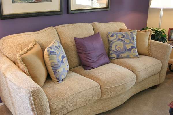 Brown Couch with a Variety of Throw Pillow Covers