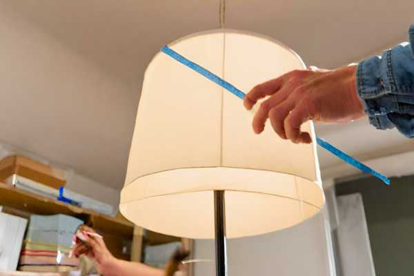 A man Measuring The Lampshade